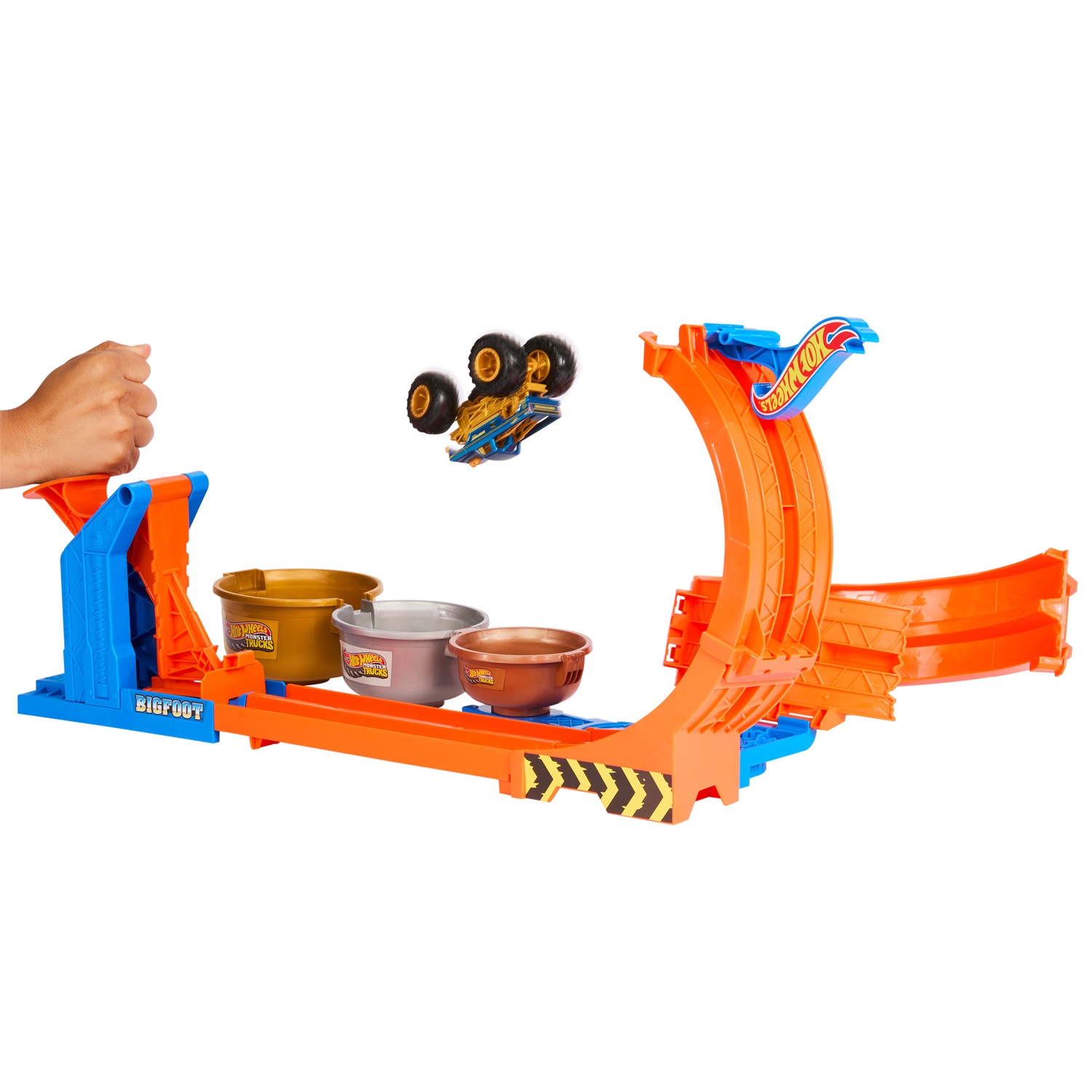 Hot Wheels JBX64 Monster Trucks - Sfida Trofeo Gira e Capovolgi Playset con Truck Bigfoot 50° Anniversario, 2 Modalità di Gioco, Giocattolo per Bambini 4 Anni